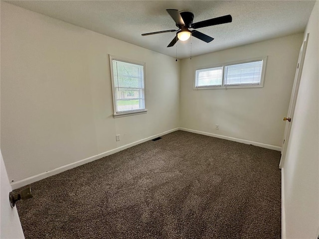 317 Marion Ave, Sikeston, MO 63801 - unfurnished room with dark carpet, baseboards, a ceiling fan, and a textured ceiling