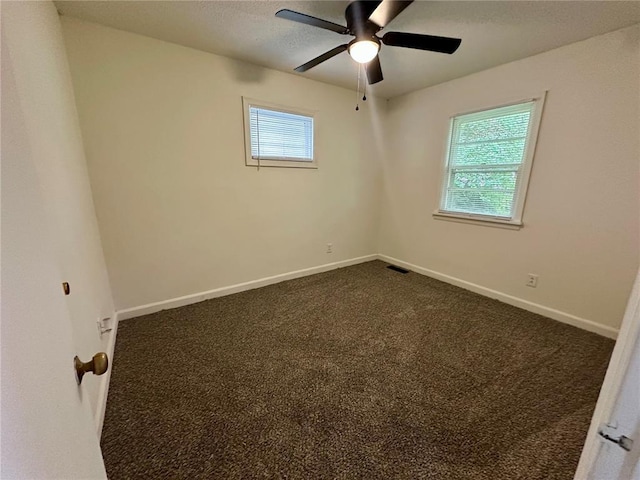 317 Marion Ave, Sikeston, MO 63801 - unfurnished room with dark colored carpet, ceiling fan, and baseboards