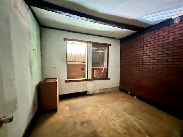 4240 California Ave, Saint Louis, MO 63111 - empty room with unfinished concrete floors and brick wall