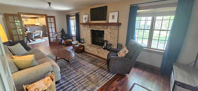 living room with plenty of natural light, dark wood finished floors, and baseboards