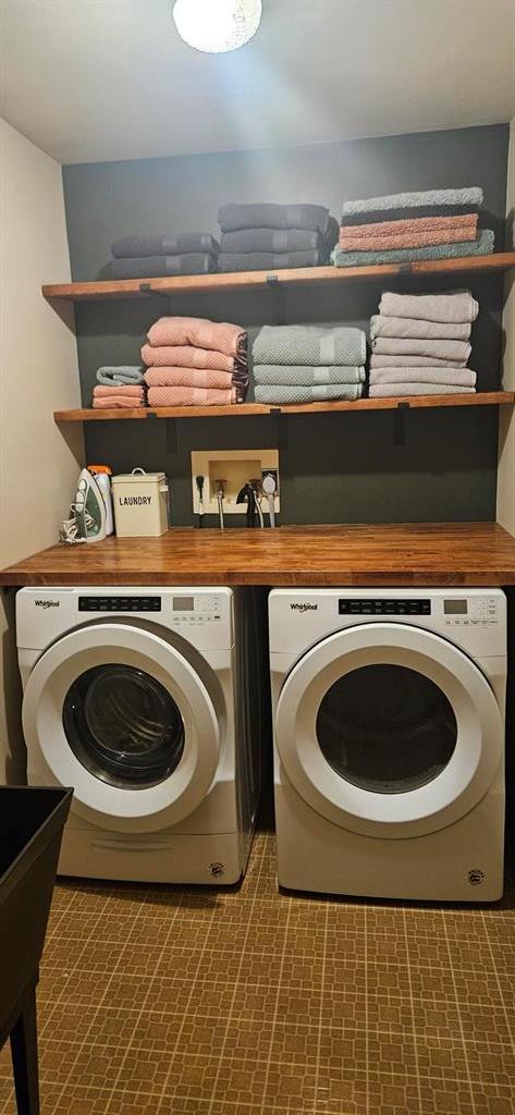 clothes washing area with independent washer and dryer