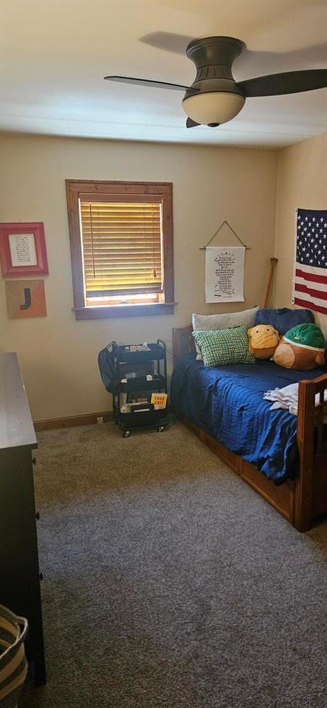carpeted bedroom featuring baseboards