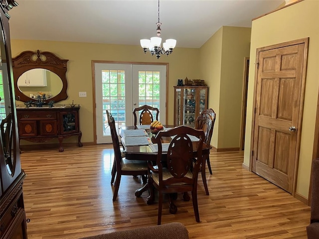 12460 Grassy Hollow Rd, Potosi, MO 63664 - dining space with a chandelier, light wood finished floors, baseboards, and french doors
