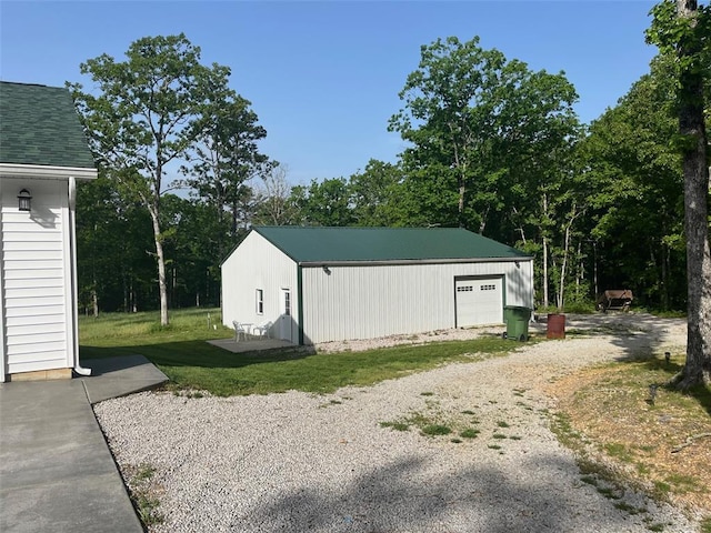 12460 Grassy Hollow Rd, Potosi, MO 63664 - view of outbuilding with driveway, an outbuilding, and view of wooded area