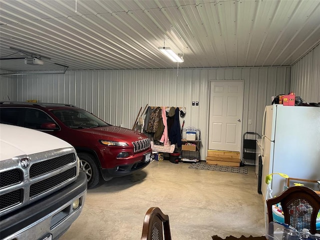 12460 Grassy Hollow Rd, Potosi, MO 63664 - garage with freestanding refrigerator and a garage door opener
