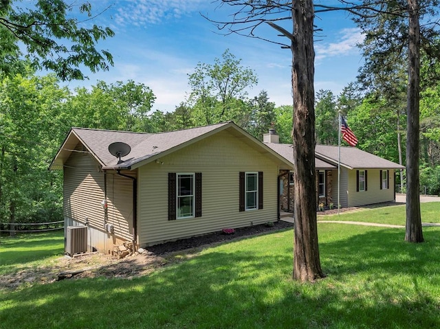 single story home featuring a front yard, central air condition unit, and a chimney