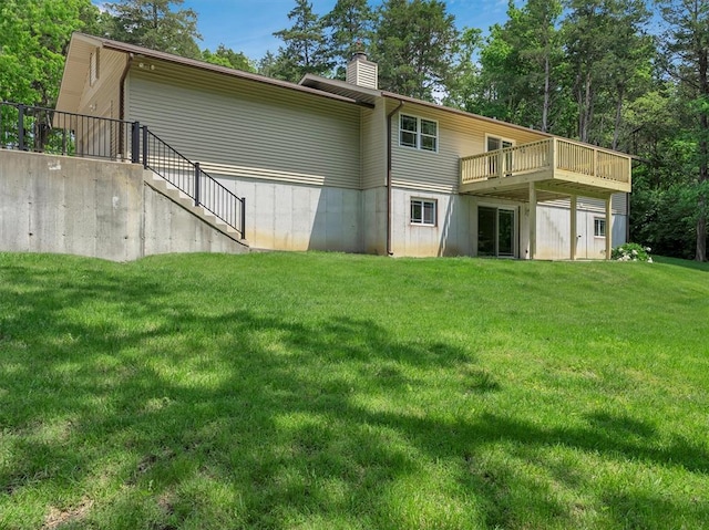 rear view of house with stairs, a wooden deck, a chimney, and a yard