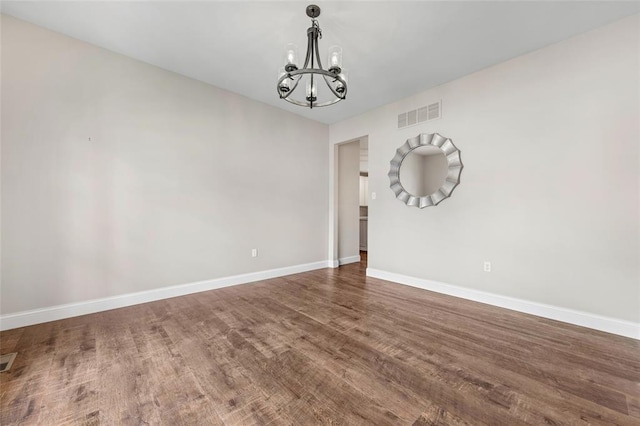 313 Golden Cherry Dr, Wildwood, MO 63040 - spare room featuring a chandelier, baseboards, and wood finished floors