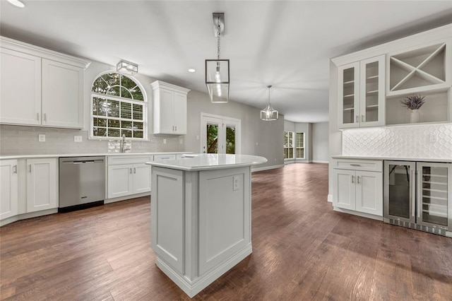 313 Golden Cherry Dr, Wildwood, MO 63040 - kitchen featuring stainless steel dishwasher, beverage cooler, tasteful backsplash, a center island, and white cabinets