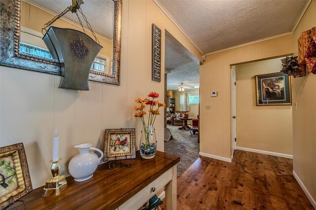310 Smith Rd, Lebanon, MO 65536 - hall featuring a textured ceiling, wood finished floors, crown molding, and baseboards