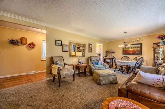 310 Smith Rd, Lebanon, MO 65536 - living area with a chandelier, ornamental molding, a textured ceiling, carpet floors, and wood finished floors