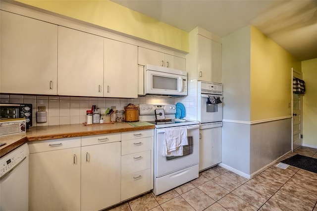 310 Smith Rd, Lebanon, MO 65536 - kitchen featuring white appliances, backsplash, light tile patterned floors, baseboards, and light countertops