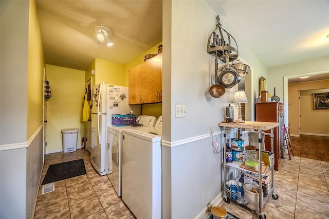 310 Smith Rd, Lebanon, MO 65536 - clothes washing area with washer and clothes dryer, cabinet space, and baseboards