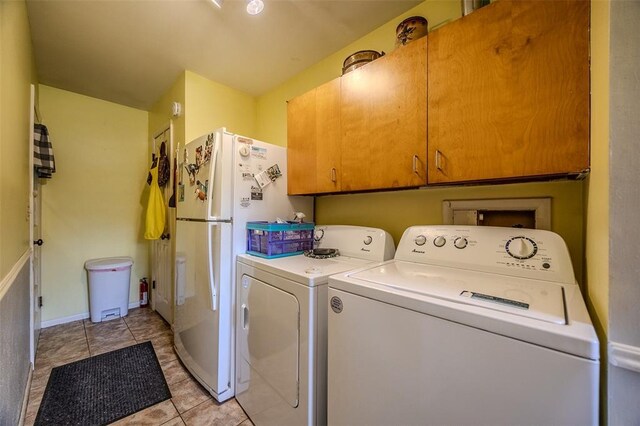 310 Smith Rd, Lebanon, MO 65536 - laundry room featuring washer and dryer, cabinet space, baseboards, and light tile patterned floors