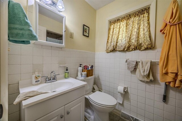 310 Smith Rd, Lebanon, MO 65536 - bathroom with toilet, tile walls, vanity, and a wainscoted wall
