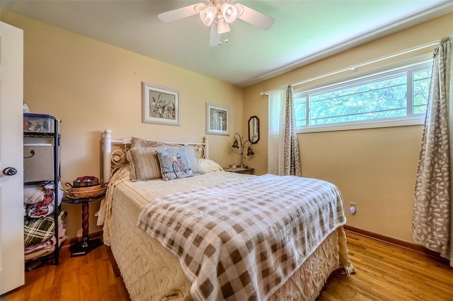 310 Smith Rd, Lebanon, MO 65536 - bedroom featuring wood finished floors, baseboards, and a ceiling fan