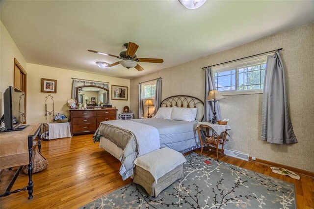 310 Smith Rd, Lebanon, MO 65536 - bedroom with multiple windows, wood finished floors, baseboards, and a ceiling fan