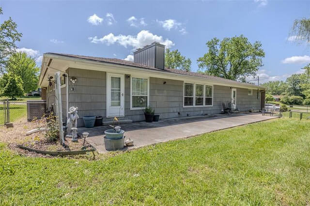 310 Smith Rd, Lebanon, MO 65536 - back of house featuring a patio area, a chimney, and central AC