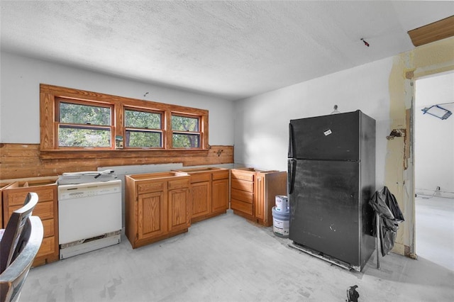 6 Clay St, Park Hills, MO 63601 - kitchen featuring freestanding refrigerator, dishwasher, concrete flooring, a textured ceiling, and brown cabinets