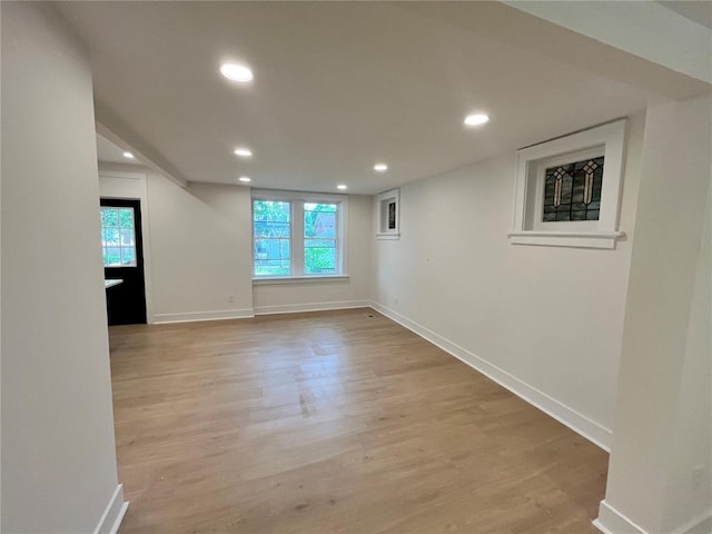 unfurnished room featuring light wood-type flooring, healthy amount of natural light, baseboards, and recessed lighting