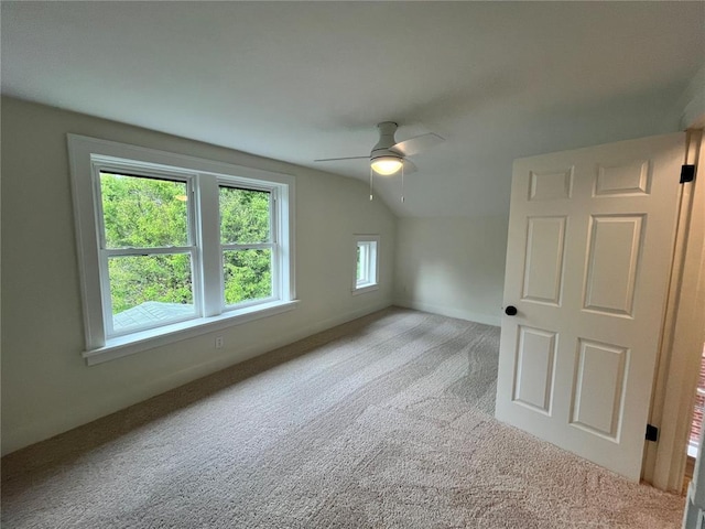 additional living space with carpet, a ceiling fan, and vaulted ceiling