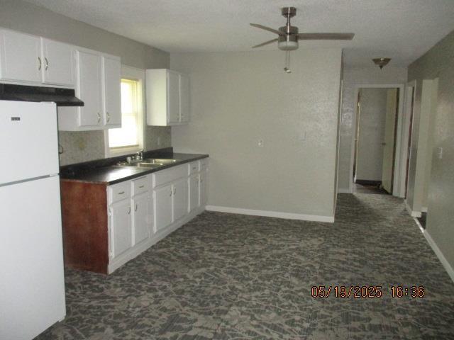 16 Richardson Dr, Union, MO 63084 - kitchen featuring freestanding refrigerator, a ceiling fan, a sink, dark carpet, and dark countertops