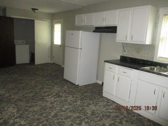 16 Richardson Dr, Union, MO 63084 - kitchen with a sink, white cabinets, freestanding refrigerator, dark countertops, and washer / dryer