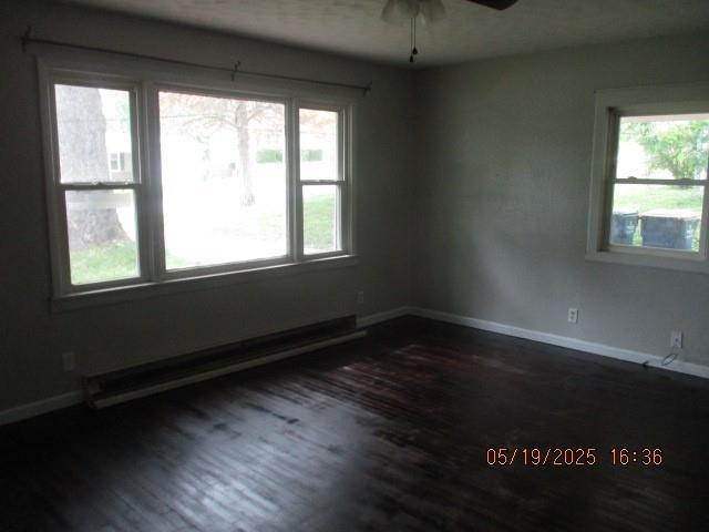 16 Richardson Dr, Union, MO 63084 - spare room with dark wood-type flooring, a ceiling fan, baseboards, and baseboard heating