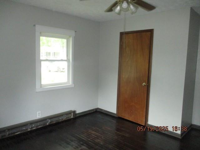 16 Richardson Dr, Union, MO 63084 - spare room with a ceiling fan, dark wood finished floors, and a baseboard heating unit