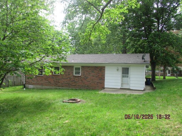 16 Richardson Dr, Union, MO 63084 - rear view of house with a lawn, a patio, and brick siding