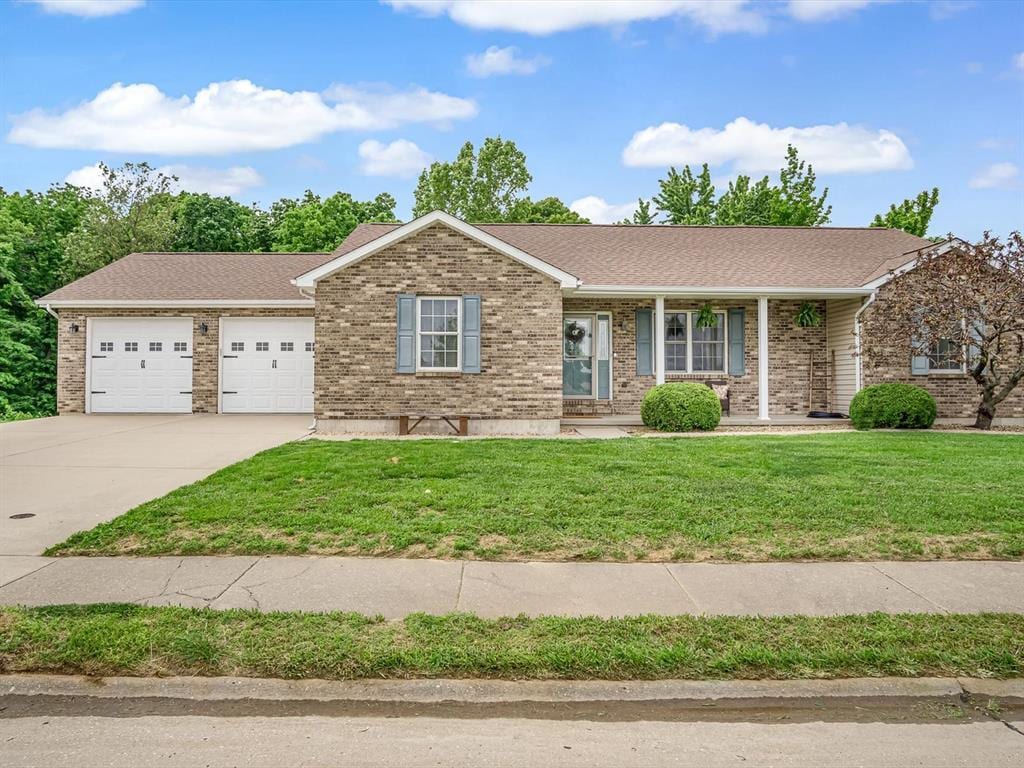 117 W Woodland Rdg, Valmeyer, IL 62295 - single story home with driveway, an attached garage, brick siding, a front yard, and roof with shingles