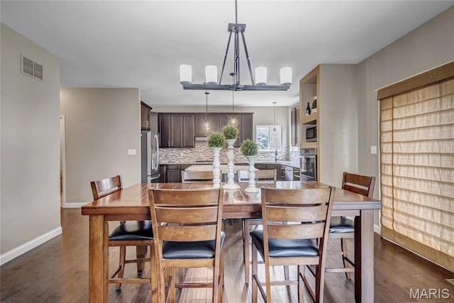 2001 Paul Renaud Blvd, Lake St Louis, MO 63367 - dining space featuring dark wood-type flooring, baseboards, and a chandelier