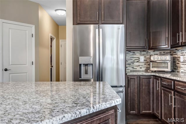 2001 Paul Renaud Blvd, Lake St Louis, MO 63367 - kitchen featuring stainless steel refrigerator with ice dispenser, decorative backsplash, and dark brown cabinetry