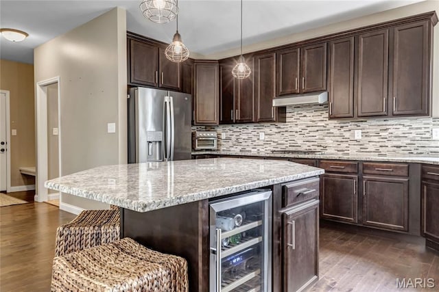 2001 Paul Renaud Blvd, Lake St Louis, MO 63367 - kitchen with wine cooler, stainless steel appliances, dark wood finished floors, a breakfast bar, and tasteful backsplash