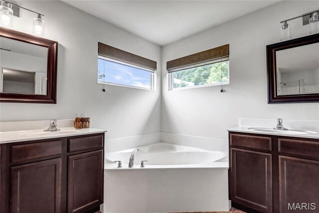 2001 Paul Renaud Blvd, Lake St Louis, MO 63367 - full bathroom featuring two vanities and a garden tub