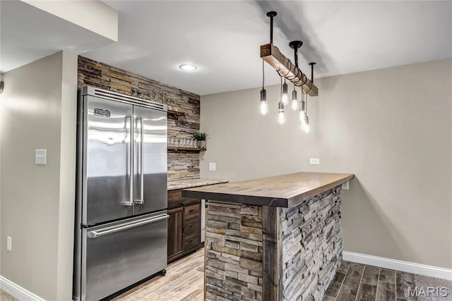 2001 Paul Renaud Blvd, Lake St Louis, MO 63367 - kitchen featuring high quality fridge, wood finish floors, tasteful backsplash, baseboards, and open shelves