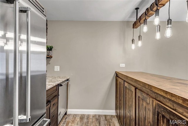 2001 Paul Renaud Blvd, Lake St Louis, MO 63367 - kitchen with appliances with stainless steel finishes, light wood finished floors, baseboards, and hanging light fixtures