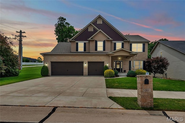 2001 Paul Renaud Blvd, Lake St Louis, MO 63367 - view of front of house with a yard, concrete driveway, an attached garage, and stone siding