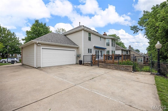 139 Foxtail Dr, Frontier Township, MO 63303 - back of house with a garage, driveway, a shingled roof, a chimney, and a deck