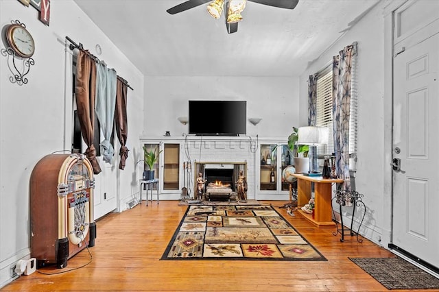 4615 San Francisco Ave, Saint Louis, MO 63115 - living area featuring ceiling fan, wood-type flooring, and a brick fireplace
