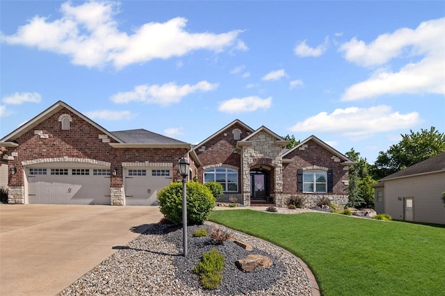 1514 Autumn St, Godfrey, IL 62035 - view of front of home with driveway, an attached garage, a front lawn, and stone siding
