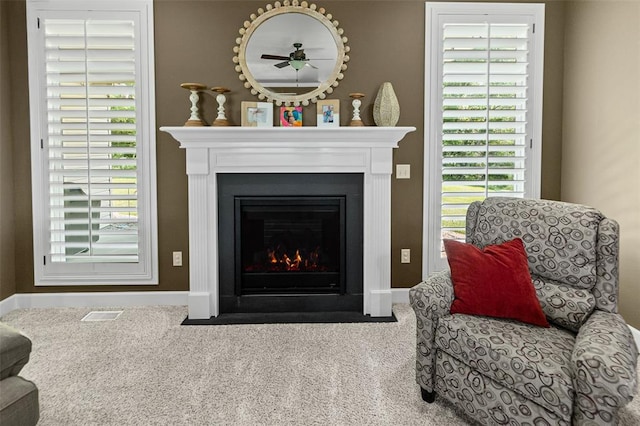 1514 Autumn St, Godfrey, IL 62035 - detailed view of carpet flooring, a fireplace with flush hearth, baseboards, and a ceiling fan