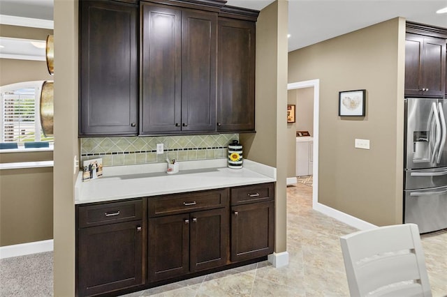 1514 Autumn St, Godfrey, IL 62035 - kitchen featuring stainless steel fridge with ice dispenser, washer / clothes dryer, dark brown cabinetry, and light countertops