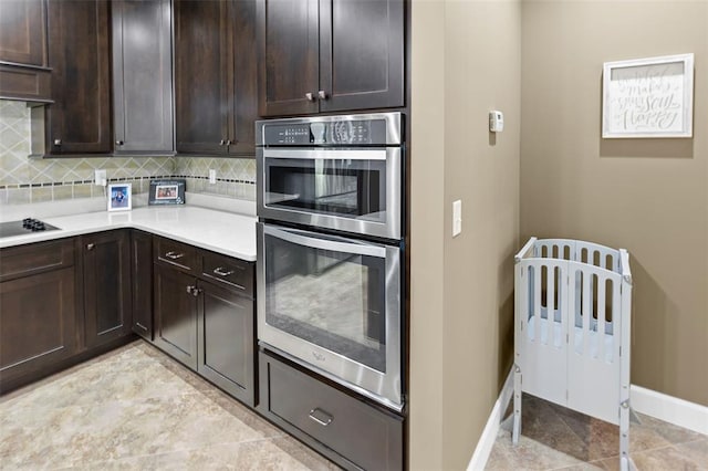 1514 Autumn St, Godfrey, IL 62035 - kitchen featuring stainless steel double oven, light countertops, baseboards, dark brown cabinetry, and decorative backsplash