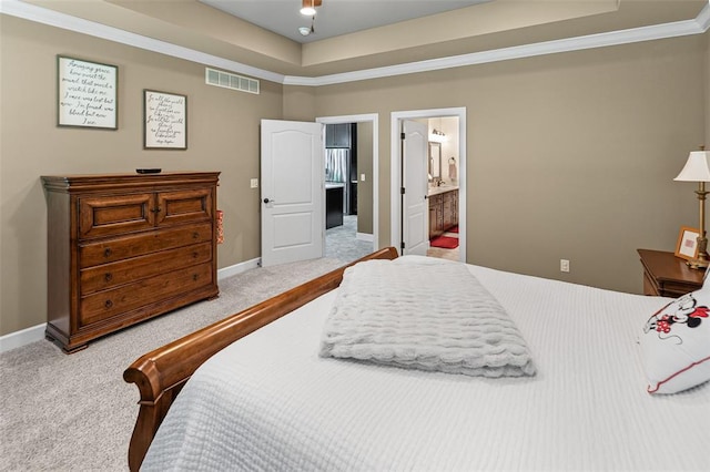1514 Autumn St, Godfrey, IL 62035 - carpeted bedroom with a tray ceiling, baseboards, and ensuite bath