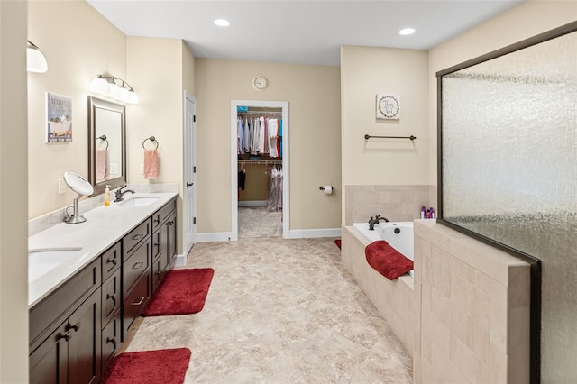 1514 Autumn St, Godfrey, IL 62035 - full bath featuring a bath, double vanity, a spacious closet, baseboards, and recessed lighting