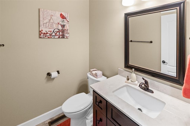 1514 Autumn St, Godfrey, IL 62035 - bathroom with toilet, vanity, and baseboards