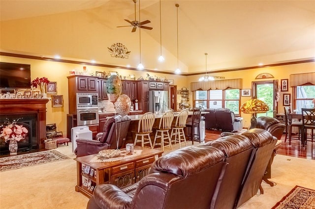 205 Hickman Dr, Bowling Green, MO 63334 - living room with a ceiling fan, high vaulted ceiling, a fireplace with flush hearth, and light colored carpet