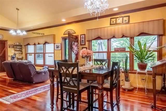 205 Hickman Dr, Bowling Green, MO 63334 - dining area with a chandelier, crown molding, wood finished floors, and lofted ceiling