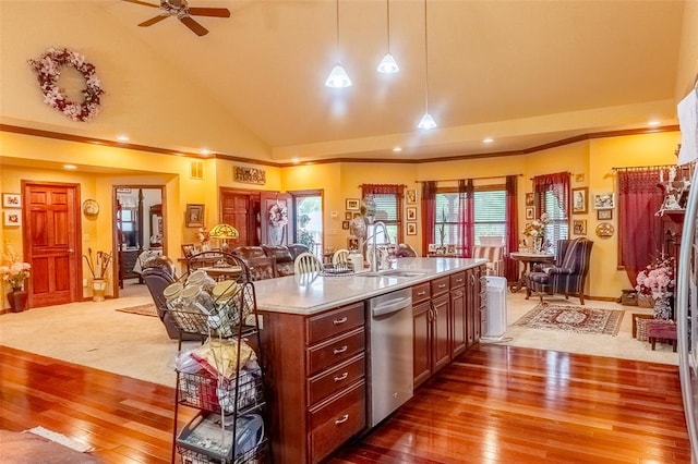 205 Hickman Dr, Bowling Green, MO 63334 - kitchen featuring stainless steel dishwasher, a sink, hardwood / wood-style flooring, vaulted ceiling, and open floor plan